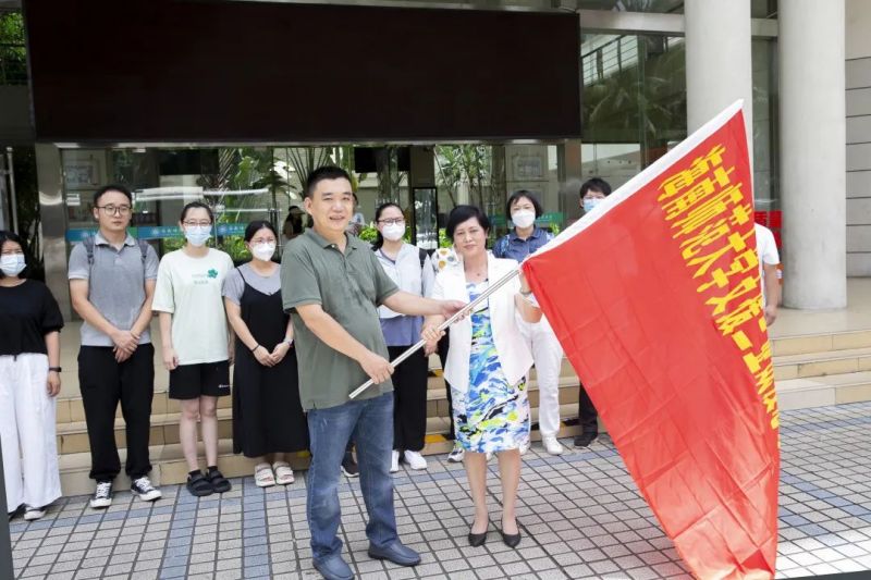 校长过建春代表学校为第一批志愿者服务队授旗送行.jpg